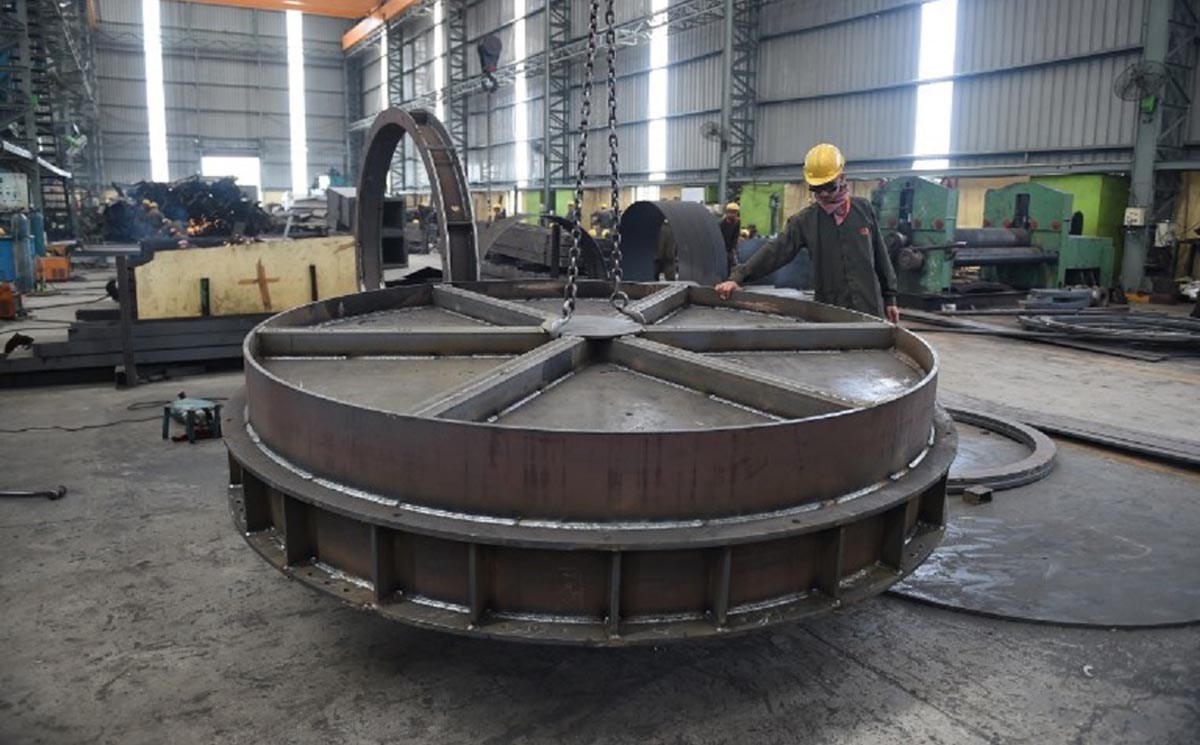 An Indian worker moves a metal structure at a plant in Kheda region, near Ahmedabad, Gujarat state. Photo: AFP