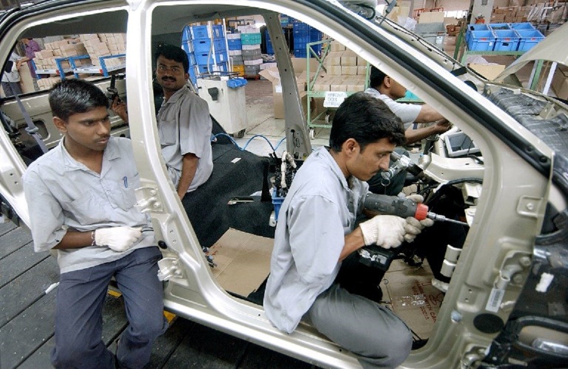 Workers assemble a car at the Tata Motors factory in Pune, India. Photo: AFP