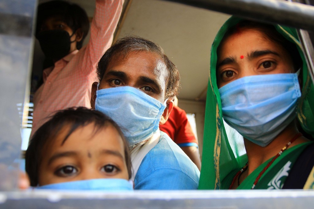 Migrants board a bus as they travel home during the ongoing Covid-19 nationwide lockdown in Jaipur, Rajasthan, India, on May 17, 2020. Photo: NurPhoto